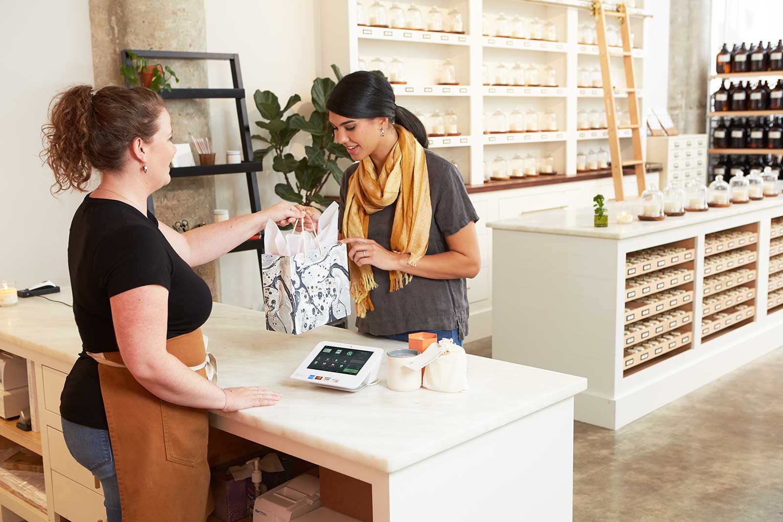 Retail Business- Counter Girl handover the product pack to the customer after received payment