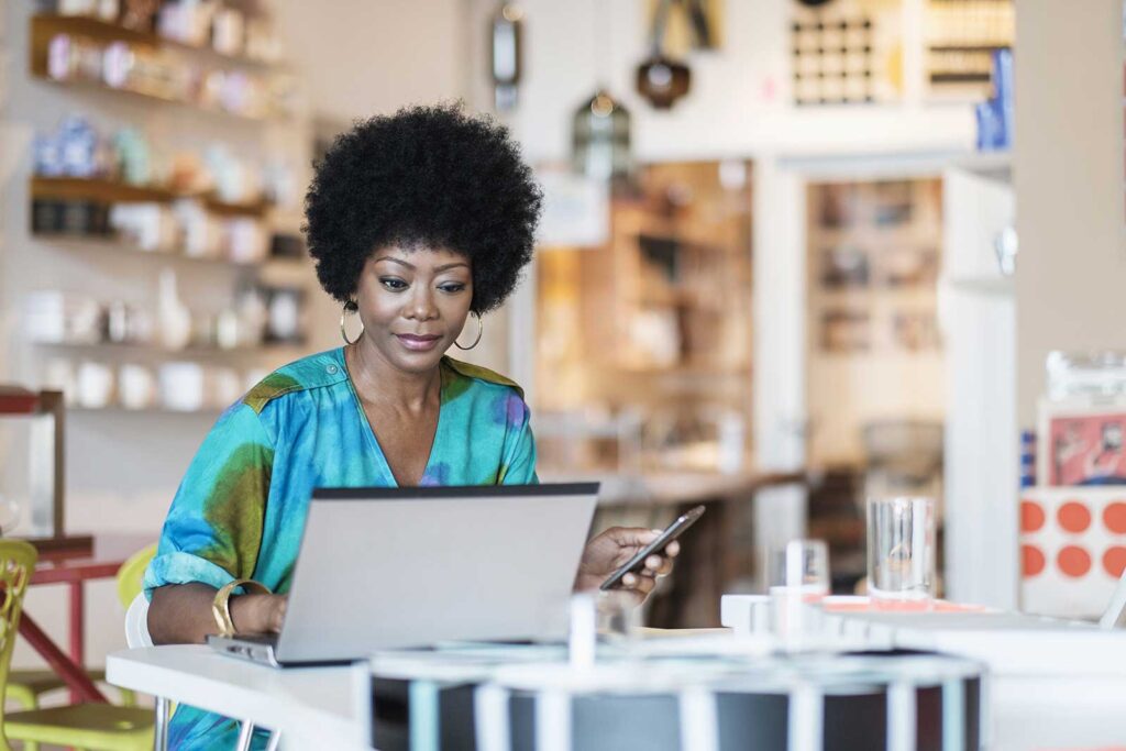 A Woman Sitting with Laptop and Mobile